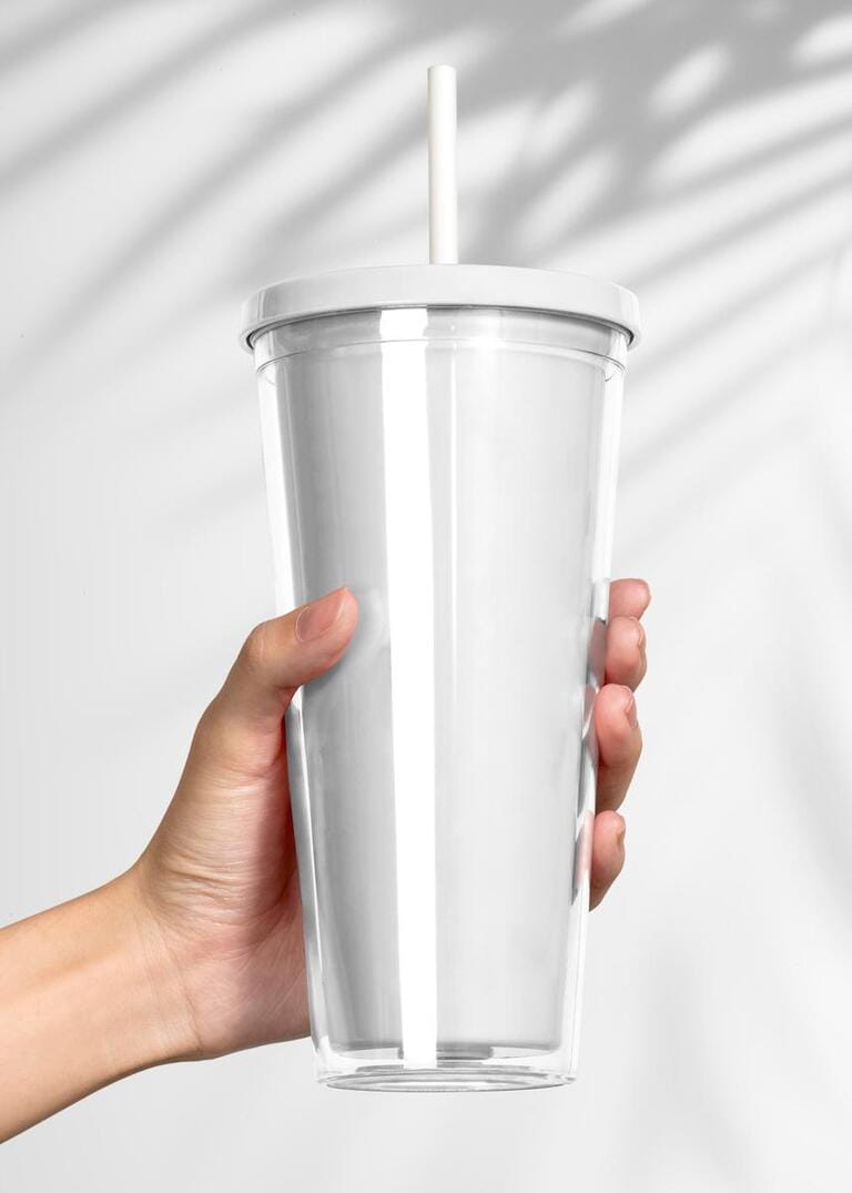 Hand holding blank white plastic tumbler
