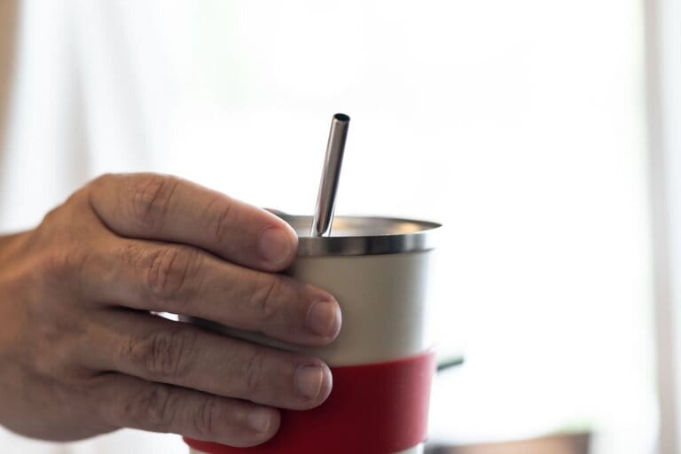 Close up reusable cup with straw . Concept for sustainability in day-to-day living.