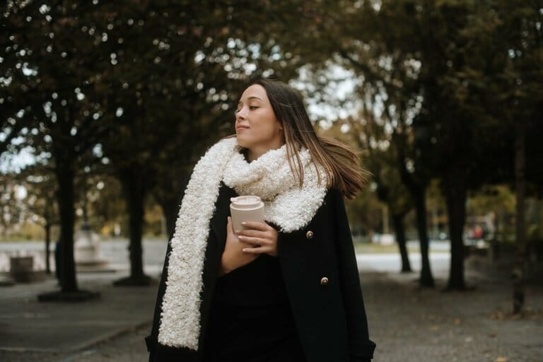 Woman with warm clothes and reusable cup